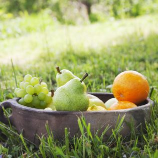 Fresh fruit. Apples, grapes, and pears  in grass . Spring nature